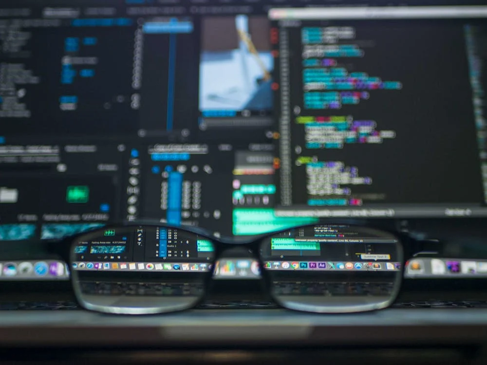 Data codes through eyeglasses showing programming